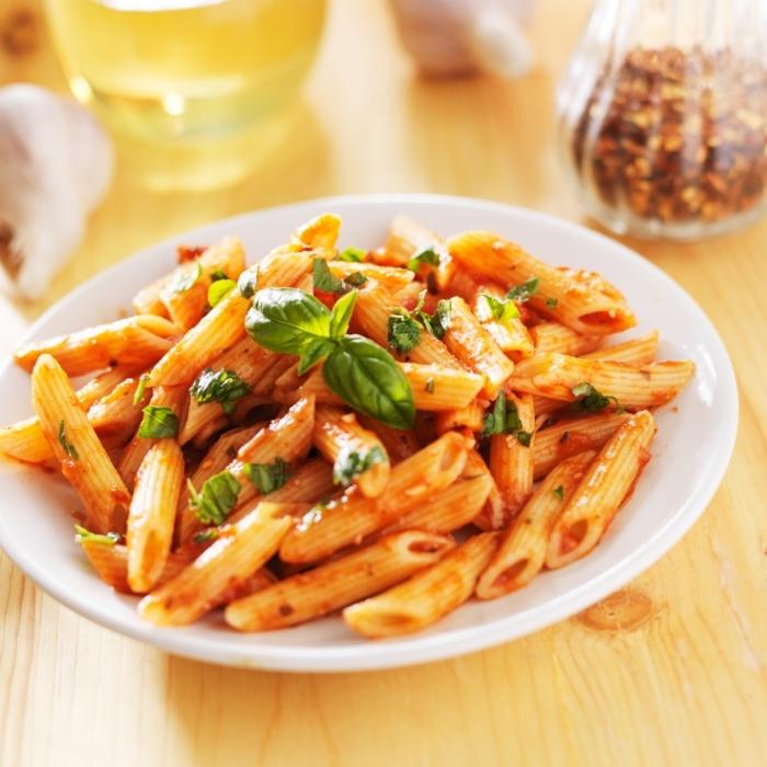Penne pasta with tomato sauce and fresh basil.