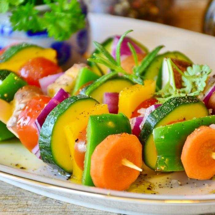 Colorful vegetable skewers brushed with olive oil and ready for the grill..
