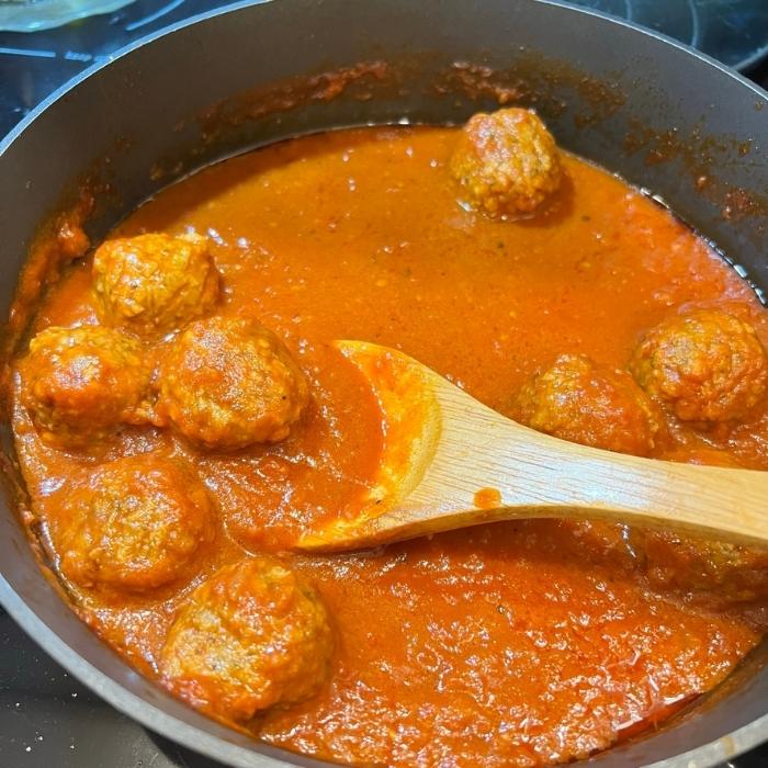 Gardein Vegan Meatballs in a pan with marinara sauce.