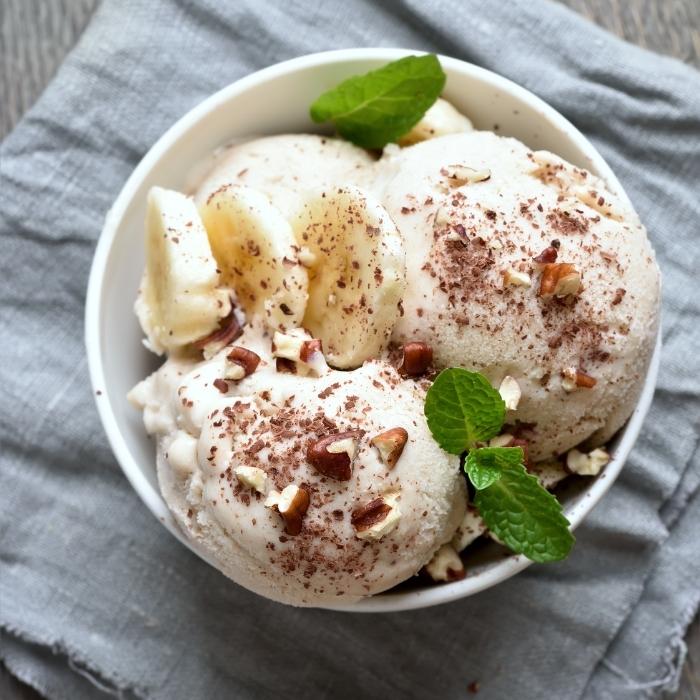 Bowl of banana nice cream with mint leaves.