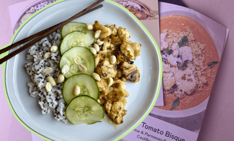 Featured graphic for a Purple Carrot meal kit review showing a plated meal of Kung Pao cauliflower with speckled rice, cucumber slices, and peanuts, with chopsticks, layered over recipe cards for other Purple Carrot dishes.